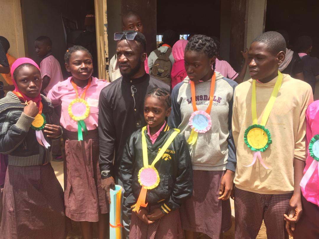 some cross-section of students posing with their award ribbon
