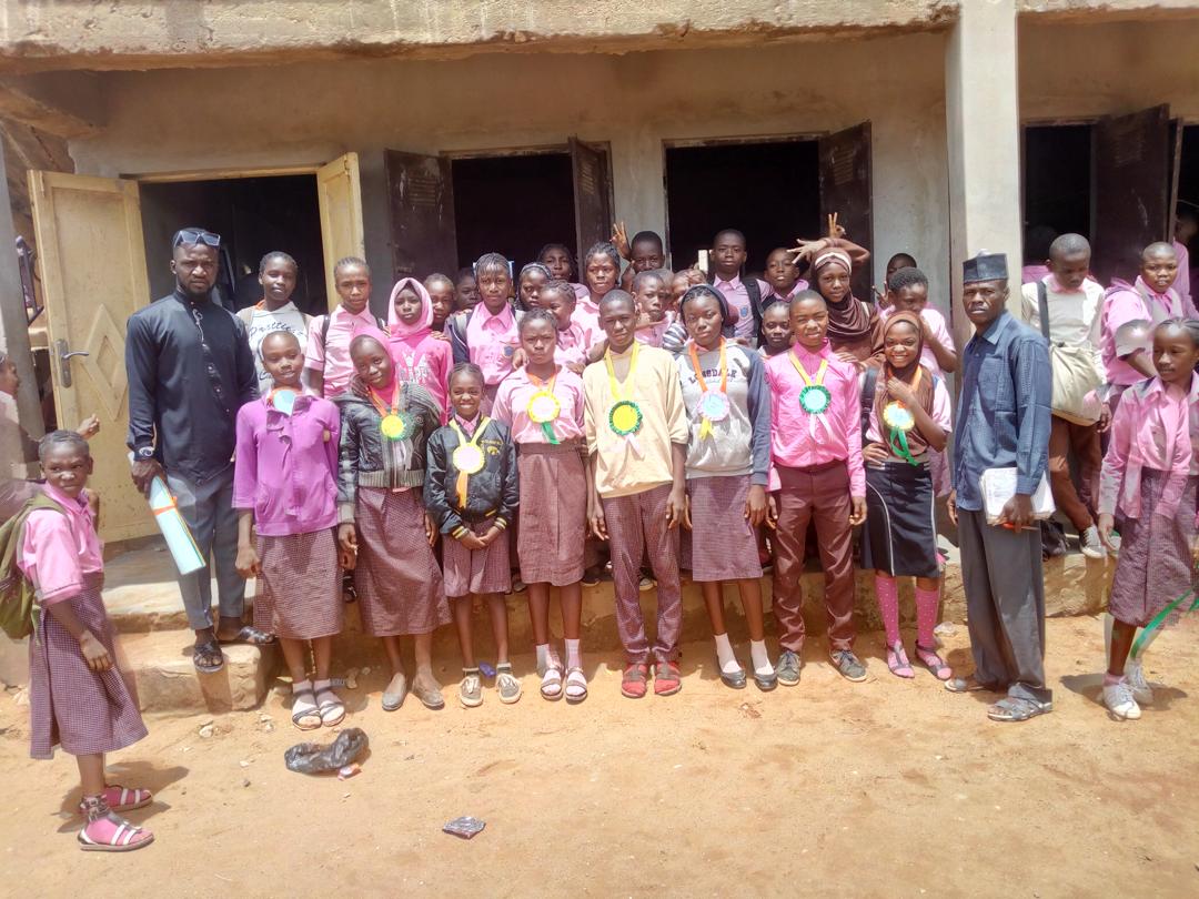 some cross-section of students posing with their award ribbon
