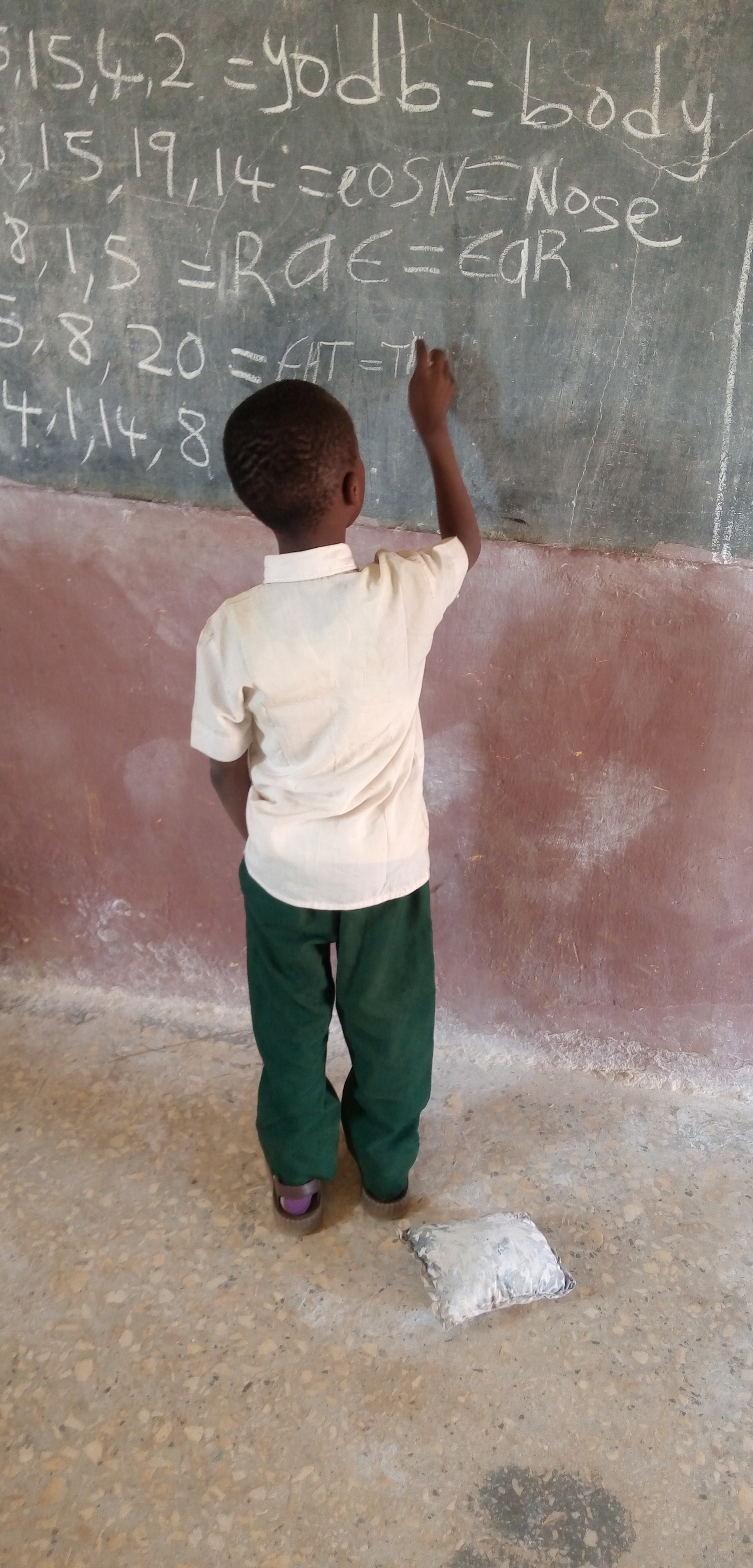 a pupil solving a code on the chalkboard