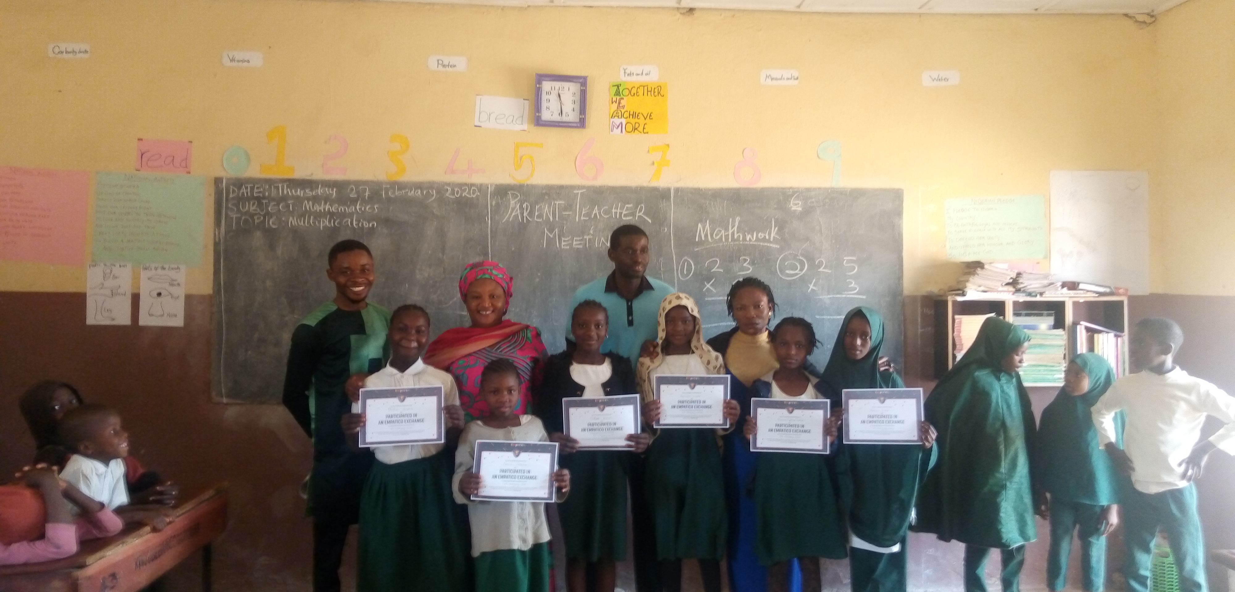 pupils showing their empatico certificate