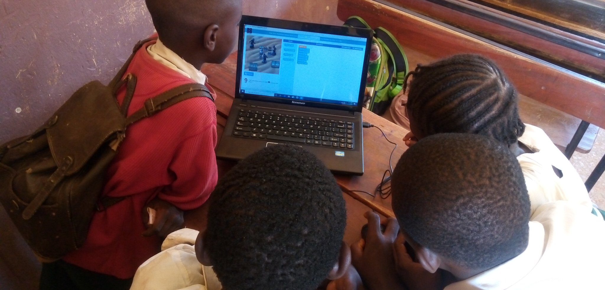 some students coding on the system