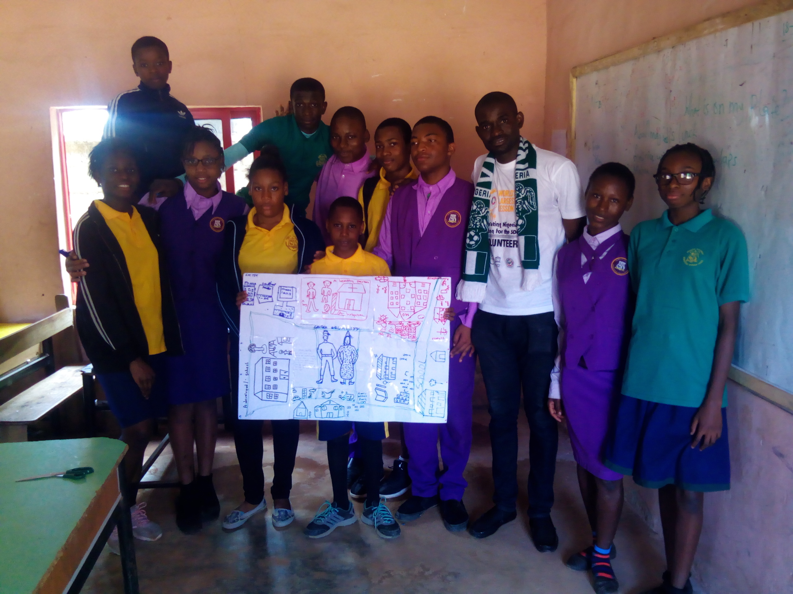 amos posing with some senior students presenting their country diagram